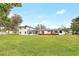 Rear exterior view of a house featuring a spacious yard and a large deck at 40 W Laurel St, Apopka, FL 32703