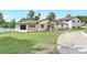 Beautiful exterior view of home with manicured lawn and lake in background at 40 W Laurel St, Apopka, FL 32703