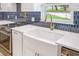 Close-up of kitchen featuring white countertops, farmhouse sink, and stylish faucet at 40 W Laurel St, Apopka, FL 32703