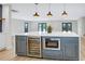 Spacious kitchen island features a wine cooler, microwave, and ample countertop space with pendant lighting at 40 W Laurel St, Apopka, FL 32703