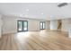 Spacious living room with French doors, stone accent wall, and ample natural light at 40 W Laurel St, Apopka, FL 32703