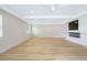Bright living room with light wood floors, recessed lighting, fireplace, and a modern ceiling fan at 40 W Laurel St, Apopka, FL 32703