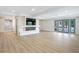 Bright living room with a modern fireplace, big screen tv, and beautiful french doors to the outdoor area at 40 W Laurel St, Apopka, FL 32703