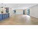 Open-concept living room with light wood flooring and plenty of natural light from the doors to the backyard at 40 W Laurel St, Apopka, FL 32703