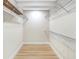 Spacious walk-in closet with laminate wood flooring and metal shelving to provide plenty of storage at 40 W Laurel St, Apopka, FL 32703