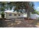 A generous backyard featuring a mature shade tree and storage shed at 4015 Kirkland Blvd, Orlando, FL 32811