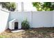 Backyard featuring a white dog house, white fence and manicured yard with plants at 4015 Kirkland Blvd, Orlando, FL 32811