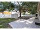 Spacious backyard with a storage shed, patio, mature trees, and white fence at 4015 Kirkland Blvd, Orlando, FL 32811