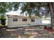 Spacious backyard featuring a shade tree, patio, privacy fence, and well-maintained lawn at 4015 Kirkland Blvd, Orlando, FL 32811