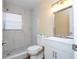 Bright bathroom featuring a tiled shower with a modern vanity and a large mirror at 4015 Kirkland Blvd, Orlando, FL 32811