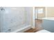 Bathroom showing a modern white tiled walk-in shower with pebble floor and wood look floors at 4015 Kirkland Blvd, Orlando, FL 32811