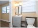 Bathroom view with a gray vanity, stylish mirror, and natural light at 4015 Kirkland Blvd, Orlando, FL 32811