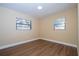 Empty bedroom showcasing neutral walls, laminate floors, and dual windows for natural light at 4015 Kirkland Blvd, Orlando, FL 32811