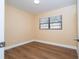 Bright, airy bedroom featuring wood flooring, neutral walls, and a window at 4015 Kirkland Blvd, Orlando, FL 32811
