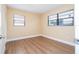 Bedroom featuring light-colored walls, wood-look flooring, and natural light at 4015 Kirkland Blvd, Orlando, FL 32811
