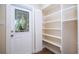 Front entryway with a decorative glass door and built-in shelving storage at 4015 Kirkland Blvd, Orlando, FL 32811