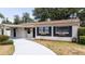 The front of the home featuring well-maintained landscaping, elegant shutters, and a paved driveway at 4015 Kirkland Blvd, Orlando, FL 32811