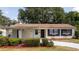 Inviting front exterior featuring a covered entrance, manicured bushes, and a well-lit walkway at 4015 Kirkland Blvd, Orlando, FL 32811