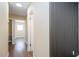 Hallway with wood-look flooring and decorative accent wall leading to the bedrooms at 4015 Kirkland Blvd, Orlando, FL 32811
