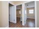 Hallway with three doors, light-colored walls, and laminate flooring, showing multiple rooms at 4015 Kirkland Blvd, Orlando, FL 32811