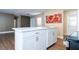 Well-designed kitchen island featuring white cabinetry, modern hardware, and a seamless transition to the living area at 4015 Kirkland Blvd, Orlando, FL 32811