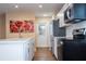 Kitchen featuring new appliances, bright lighting, hardwood floors, and a door leading outside at 4015 Kirkland Blvd, Orlando, FL 32811