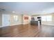 Expansive living room features wood-look flooring, recessed lighting, a modern kitchen, and a welcoming entryway at 4015 Kirkland Blvd, Orlando, FL 32811