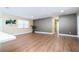 Spacious living room with wood-look flooring, neutral walls, recessed lighting, and a view of the kitchen at 4015 Kirkland Blvd, Orlando, FL 32811