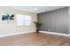 Living room featuring hardwood floors, window, wall art, and modern lighting fixtures at 4015 Kirkland Blvd, Orlando, FL 32811