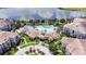 Aerial view of the community featuring pool, landscaping, and a beautiful lake in the background at 4024 Breakview Dr # 40604, Orlando, FL 32819
