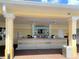 The outdoor bar features a tile front, granite countertop, liquor selection, TV and ceiling fans at 4024 Breakview Dr # 40604, Orlando, FL 32819