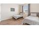 Bright bedroom with two twin beds, wood floors, and window at 4024 Breakview Dr # 40604, Orlando, FL 32819