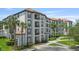Attractive condominium building with private balconies, tile roof and tropical landscaping at 4024 Breakview Dr # 40604, Orlando, FL 32819