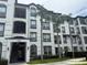 Stunning condo building featuring multiple stories, balconies, and beautiful tropical landscaping at 4024 Breakview Dr # 40604, Orlando, FL 32819