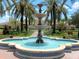 Picturesque multi-tiered fountain surrounded by lush landscaping, benches, and a manicured walkway at 4024 Breakview Dr # 40604, Orlando, FL 32819