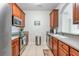 Fully equipped kitchen with stainless steel appliances and wood cabinets at 4024 Breakview Dr # 40604, Orlando, FL 32819