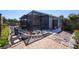 Landscaped backyard with a screened-in patio and stepping stones leading to gardens at 4216 Cricket Hollow Cv, Casselberry, FL 32707