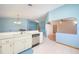 White kitchen with stainless steel dishwasher, an open design, and tiled floors at 4216 Cricket Hollow Cv, Casselberry, FL 32707