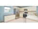Well-lit kitchen with stainless steel appliances and white countertops, backsplash, and cabinets at 4216 Cricket Hollow Cv, Casselberry, FL 32707