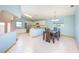 Open-concept kitchen and dining area with white tile flooring and lots of natural light at 4216 Cricket Hollow Cv, Casselberry, FL 32707
