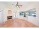 Comfortable living room with a brick fireplace and tiled floors, view of the kitchen at 4216 Cricket Hollow Cv, Casselberry, FL 32707