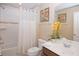 A bathroom with a tub with shower, a toilet, a sink and a mirror at 4405 Acorn Ct, Davenport, FL 33837