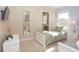 Inviting bedroom featuring twin beds, neutral tones, TV, and a door leading to the bathroom at 4405 Acorn Ct, Davenport, FL 33837