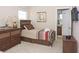 Stylish bedroom featuring a bed, a dresser and TV with the door leading to the bathroom at 4405 Acorn Ct, Davenport, FL 33837