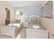 Charming bedroom with two twin beds, complemented by stylish decor and ample natural light at 4405 Acorn Ct, Davenport, FL 33837