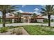 Community clubhouse entry with archway, and professional landscaping at 4405 Acorn Ct, Davenport, FL 33837