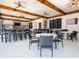 Community clubhouse lounge area with tables, chairs, TVs, and a bar area at 4405 Acorn Ct, Davenport, FL 33837