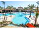Resort style community pool with beach access and palm tree landscaping at 4405 Acorn Ct, Davenport, FL 33837