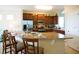 Open kitchen with granite countertops, stainless steel appliances, and a breakfast bar for casual dining at 4405 Acorn Ct, Davenport, FL 33837