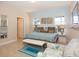 Spacious bedroom featuring a blue-themed decor with ample natural light and a tiled floor at 4405 Acorn Ct, Davenport, FL 33837